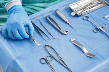 Dentist hand taking instrument for dental treatment