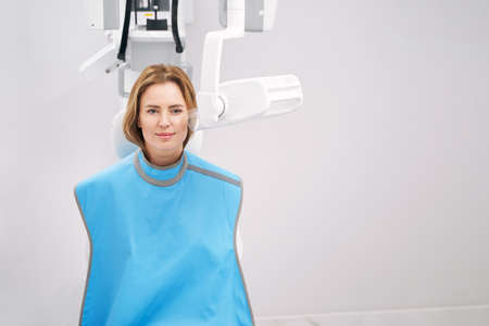 Woman using dental diagnostic equipment in stomatology clinicの写真素材