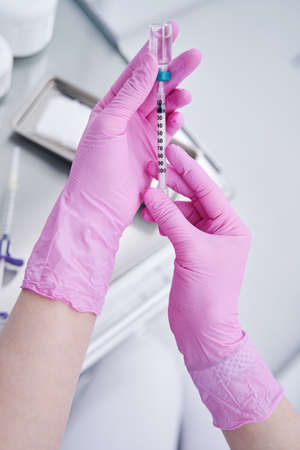 Focused photo on practitioner that filling syringeの写真素材