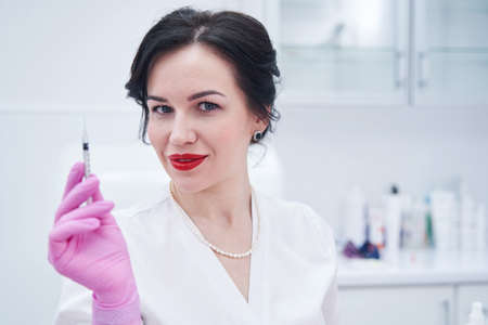 Portrait of pretty cosmetologist posing on cameraの写真素材