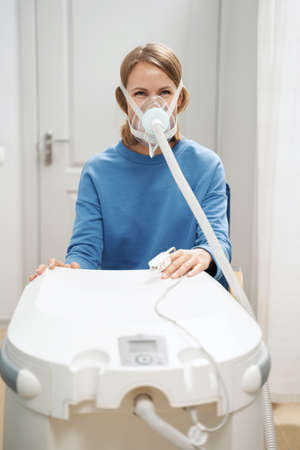 Woman receiving interval hypoxic treatment in clinicの写真素材