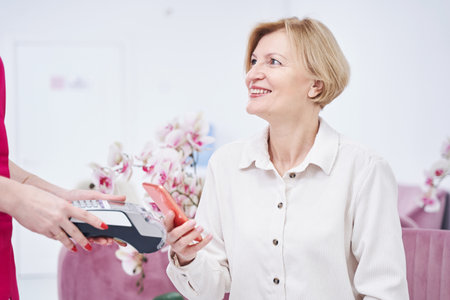 Positive delighted female person looking at assistant