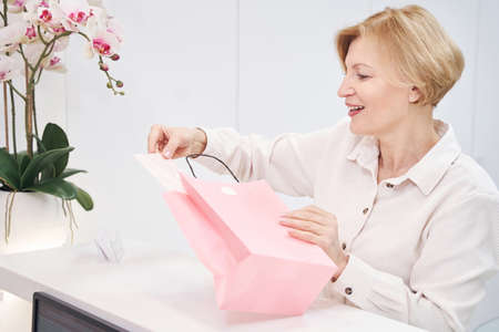 Portrait of happy woman taking gift cardの写真素材