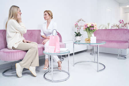 Young female patient having conversation with doctorの写真素材