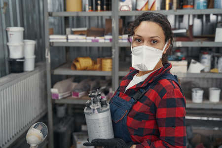 Close up of serious woman standing near rack