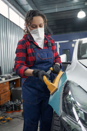 Pretty woman preparing auto body for coloringの写真素材