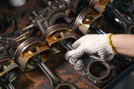 Auto mechanic repairing car parts in automobile garageの写真素材