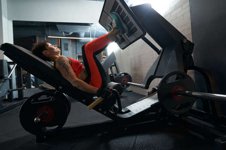 Sportswoman using gym equipment during resistance training