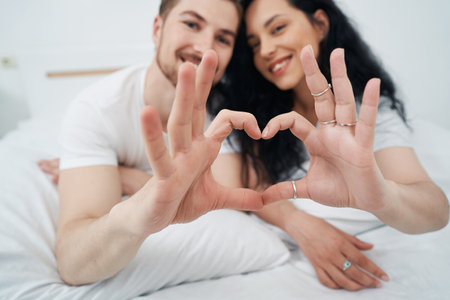 Young couple in love showing heart-hand symbolの写真素材
