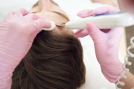 Forehead skin treatment with ultrasonic skin scrubber