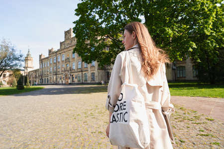 Elegant woman with eco bag and laptop outdoors