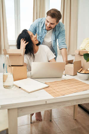 Cheerful male and female working in home officeの写真素材