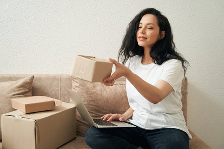 Joyous young woman holding package in hand