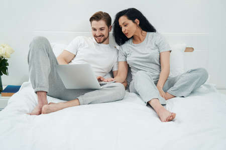 Young couple watching something on portable computerの写真素材