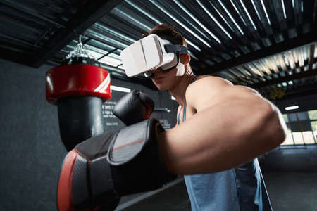 Serious adult sportsman exercising in virtual realityの写真素材