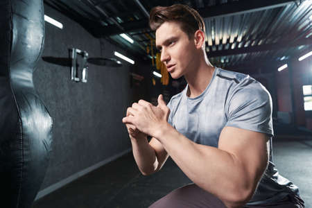 Determined male athlete working out at gymの写真素材