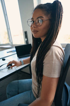 Female office worker posing for camera in workplaceの写真素材