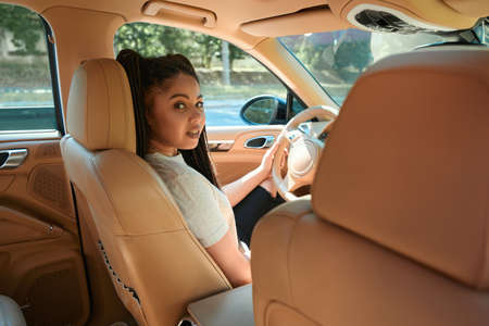 Tranquil confident modern woman is driving passenger car