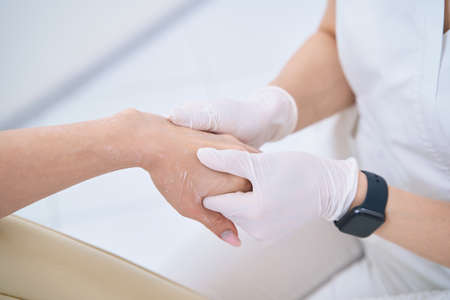 Woman in the medical and cosmetology center on the procedure of hand massageの写真素材