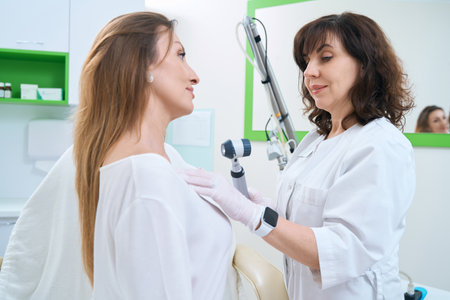 Patient on examination by a dermatologist in a medical dermatological centerの写真素材