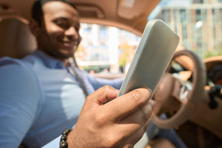 Driver using his cellphone during car trip