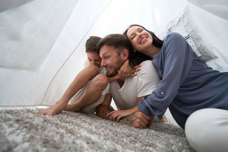 Joyful family communication in a children hutの写真素材