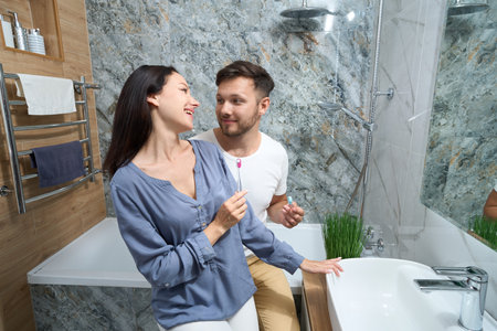 Guy and the female happily communicating in the bathroom