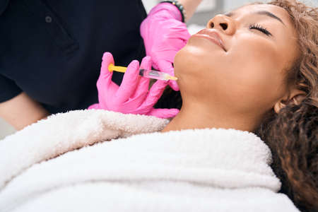 Patient undergoing a chin correction procedure with botulinum toxin injections