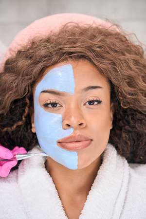 Female on alternative facial cleansing procedure in beauty and health clinic