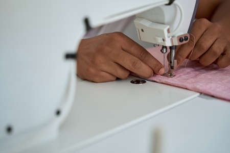 Male tailor making bespoken clothes in own atelier