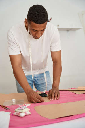 African American man making clothes in atelierの写真素材