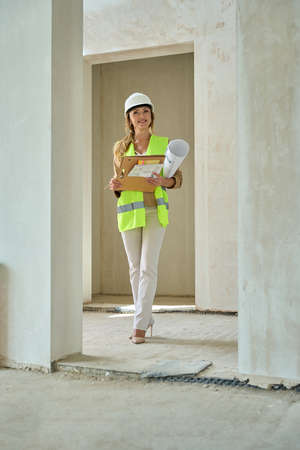 Smiling realtor walking around an unfinished houseの写真素材