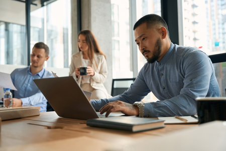 Close up portrait of handsome confident male working on notebookの写真素材
