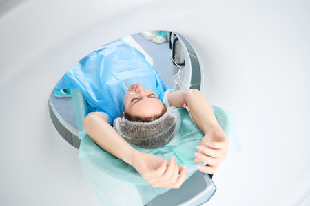 Woman undergoing a CT scan procedure in medical center