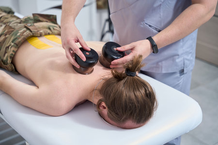 Physiotherapist in a rehabilitation ward conducts a medical procedureの写真素材