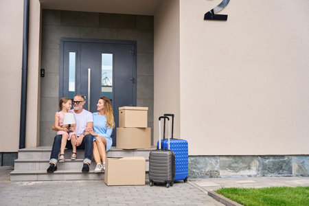 Portrait of family on steps of house on moving dayの写真素材