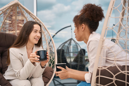 Business ladies having conversation at coffee breakの写真素材