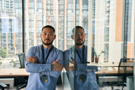 Tranquil corporate manager posing for camera in workplaceの写真素材