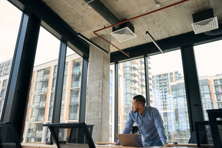 Young Asian company employee in his workplace