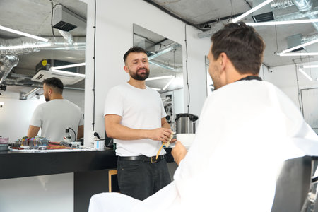 Amazing hairstylist providing best customer service to hair salon visitorの写真素材