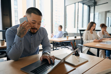 Focused corporate employee typing on his laptopの写真素材