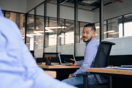 Corporate worker seated at his office deskの写真素材