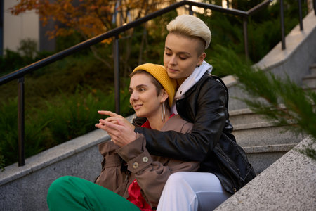 Woman hugged her smiling girlfriend fromback, they are LGBT coupleの写真素材