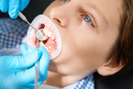 Child undergoes an oral examination in an outpatient clinicの写真素材