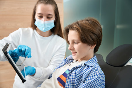 Boy at a dentist appointment, a woman dentist advisesの写真素材