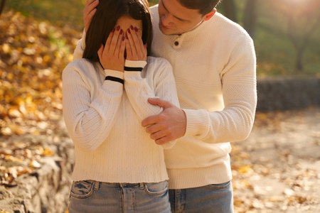 Guy gently comforts a crying girlfriend in a city park