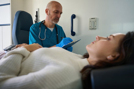 Doctor in medical uniform and sterile gloves is making notes