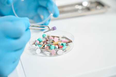 Experienced stomatologist preparing to perform teeth-polishing procedureの写真素材