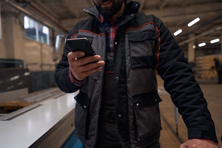Man holding mobile phone and chatting at work
