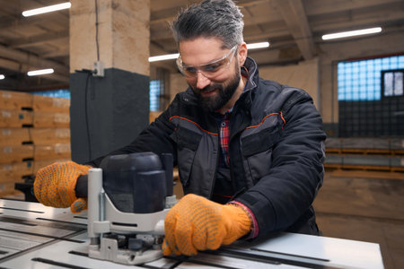 Adult man working with wood, cutting with instrument